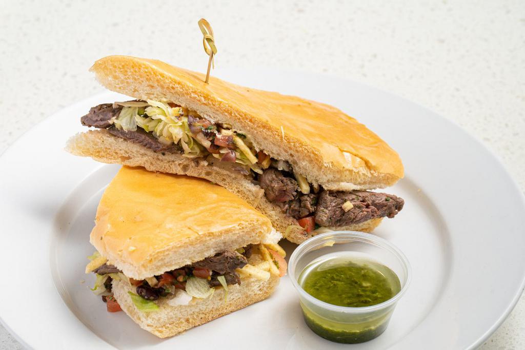 Churrasco Sandwich · Grilled skirt steak topped with grilled onions, lettuce, black bean pico de gallo ＆ potato stickes on toasted Cuban bread with side of Chimichurri sauce.
