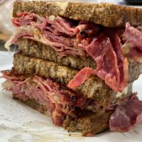 Reuben  · Corned beef, Swiss, sauerkraut and Russian dressing served on toasted marble rye