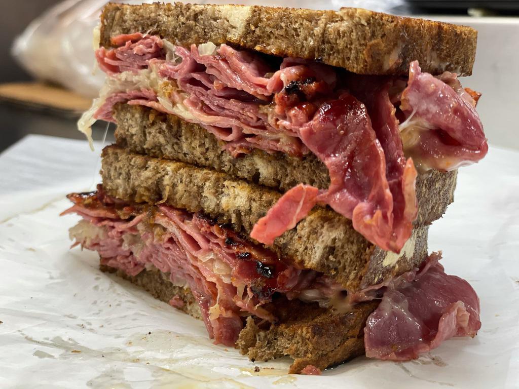Reuben  · Corned beef, Swiss, sauerkraut and Russian dressing served on toasted marble rye