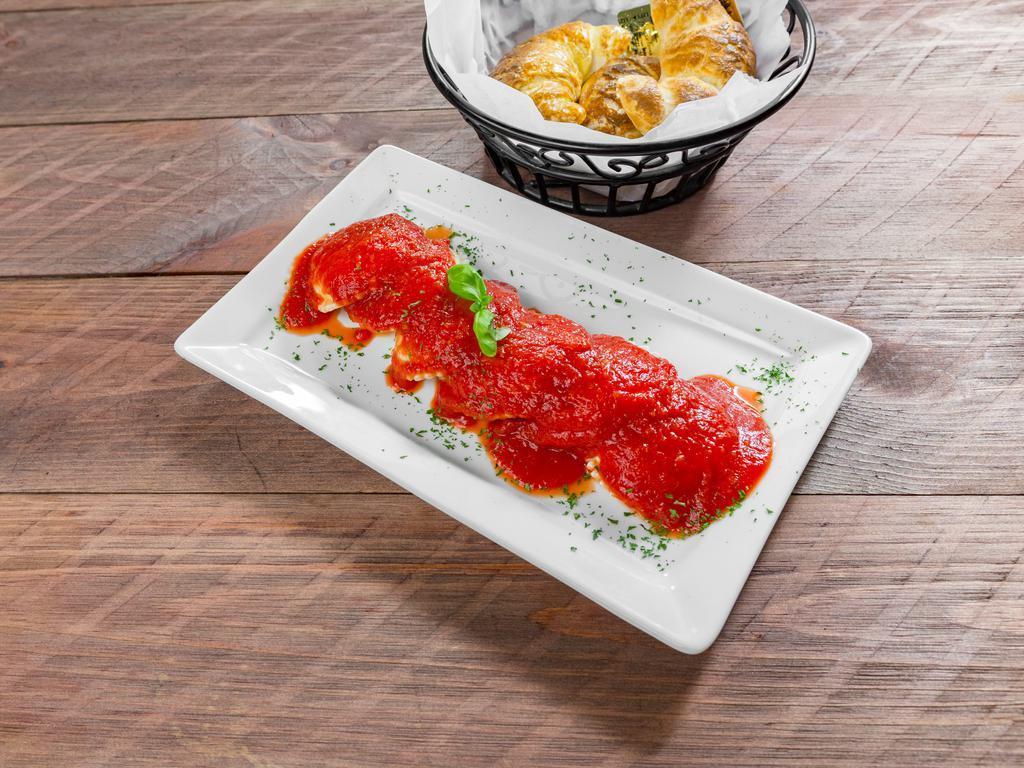 Cheese Ravioli · Pasta shells stuffed with ricotta cheese, topped with mozzarella cheese and tomato sauce.