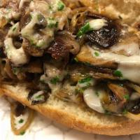 Ribeye Cheesesteak · Thinly Sliced Ribeye, Scotch Onions, Mushrooms, Provolone Cheese, House baked Sesame Roll. 