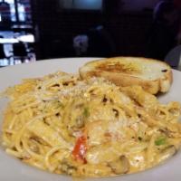 Rajun Pasta (Chicken) · Scratch made to order Alfredo tossed with al dente pasta, slow roasted tomatoes, double smok...