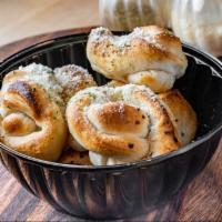 Garlic Knots · Bread, topped with cheese, garlic & olive butter, herb seasoning, baked to perfection.
