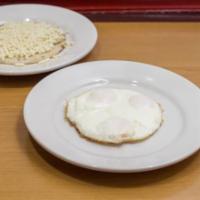 Huevos Fritos · Fried eggs, corn cake with cheese and hot chocolate or coffee.