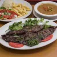 Churrasco Argentino · Flat meat with rice, beans, salad, and french fries.