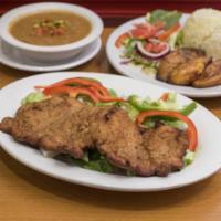 Chuleta Calena · Breaded pork loin with rice, beans, salad, and sweet plantains.