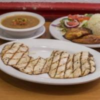 Pollo a La Plancha · Grilled chicken breast with rice, beans, salad and sweet plantains.