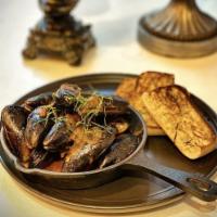 Mussel Curry · Mussel in creamy red curry sauce served with breads.