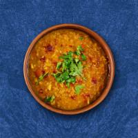 Lucid Yellow Lentil · Cumin and garlic tempered yellow lentil with onion and tomatoes
