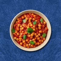 Champion Chickpea · Slow-cooked chickpeas with spices mixed with onion and tomatoes
