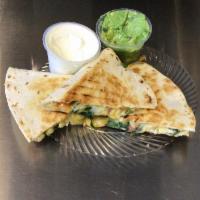 The Works Quesadilla · Spinach, chicken, tomatoes, green pepper, onions, cilantro, chicken, and 3 kinds of cheese.