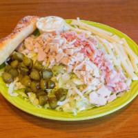 Maurice Salad · Ham, turkey, Swiss cheese and sweet pickles served on a bed of shredded iceberg lettuce with...