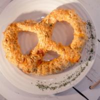 Crab Pretzel JUMBO · Our delicious homemade crab dip over a JUMBO oven baked pretzel, cheddar cheese and old bay.
