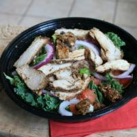 Masala Chicken Salad Bowl · A salad bowl consisting of kale, brussel sprouts, onions, tomatoes, and chicken served with ...
