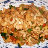 Chicken with Nuts · Sliced stir-fried chicken with vegetables like zucchini, onions, and celery in a tangy brown...