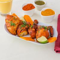 Tandoori Chicken · Two chicken leg thigh marinated in spices and cooked.