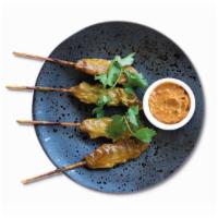 Chargrilled Chicken Skewers · Marinated tender chicken skewers smothered in peanut satay sauce. Not Spicy.