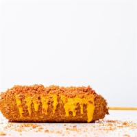 Taki Korean Corn Dog · Jumbo frank on a stick hand dipped inhouse made yeasted dough rolled in a crushed takis tort...
