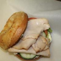 Yummy Turkey Sandwich · Smoked turkey, onion chive cream cheese, lettuce, tomato and cucumbers on an Asiago cheese b...