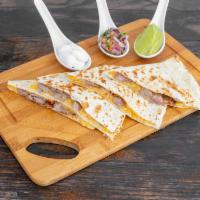 Quesadillas · Fresh guacamole and sour cream.