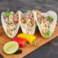 Fusion Tacos · 3 soft tacos, cheese, sour cream, chipotle, caramelized onion, and pico de gallo.