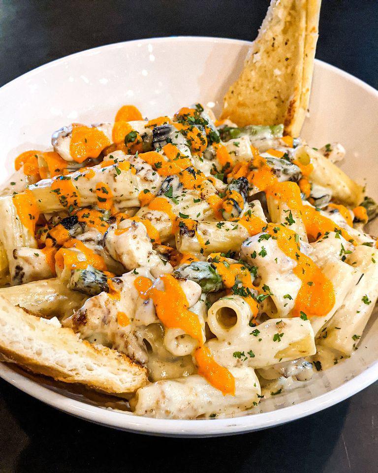 Chicken Alfredo · Rigatoni noodles tossed with Alfredo, grilled chicken, and asparagus. Drizzled with roasted red pepper pesto.