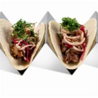 Pulled BBQ Pork Taco · 2 pieces. Pork, pickled onion, shallots, and cilantro.