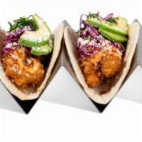 Shrimp Taco · 2 pieces. Shrimp, spicy mayonnaise, pickled red cabbage, queso, avocado, and cilantro.