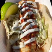 Grilled Ono Taco · We use a spicy marinade for our Ono fillets, then we grill them to perfection. Served on cor...