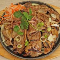 E3. Sizzling Pork Chop 鐵板豬扒 · Thick cut of meat from a pig typically cut from the spine.