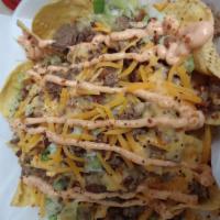 Bacon Cheeseburger Nachos  · Fresh Tortilla Chips loaded with Beef, Lettuce, Tomatoes, Onions, Nacho cheese, Special sauc...