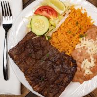 Carne Asada · Served with Spanish rice, refried beans, lettuce, tomatoes, sour cream and warm tortillas. F...