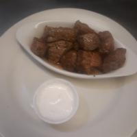 Steak Bites · Seasoned steak bites with a side of horseradish sauce.