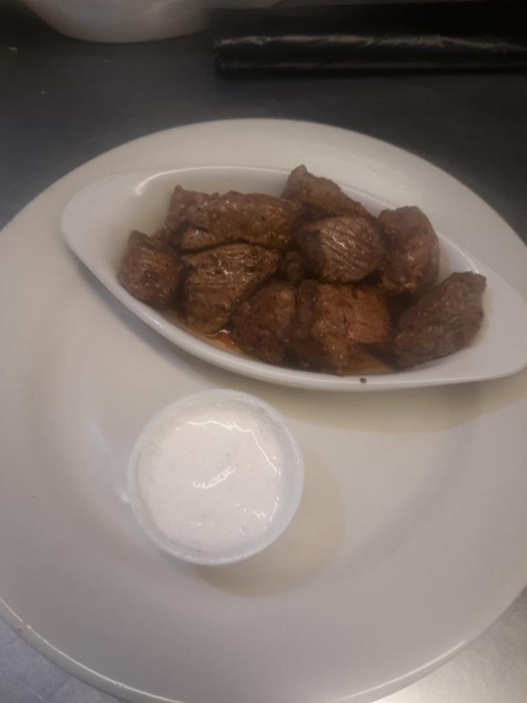 Steak Bites · Seasoned steak bites with a side of horseradish sauce.