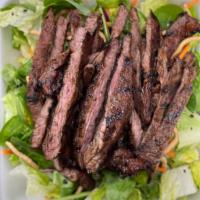 Grilled Steak Salad · Our tender grilled teriyaki steak on a bed of fresh greens topped with our house-made asian ...