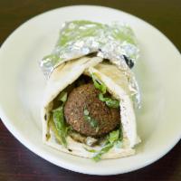 52. Falafel Sandwich · Served in a pita wrap with hummus, tomato, pickle, lettuce, tahini, lemon juice and hot sauc...