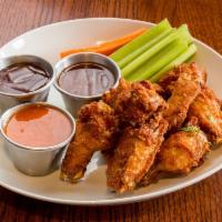 Slow Smoked Wings · Choice of Buffalo, Bourbon BBQ, or Sweet Chili. Served with carrots, celery, and ranch.