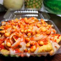 Tostilocos · A bag of tostitos chips on a plate filled with cucumbers, Jamaica, Japanese style peanuts, c...