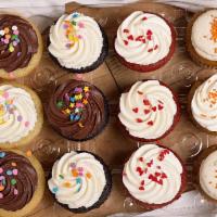 Dozen Assorted Classic Cupcakes · An assortment of our classic flavors - vanilla, chocolate, red velvet, and carrot cake, topp...