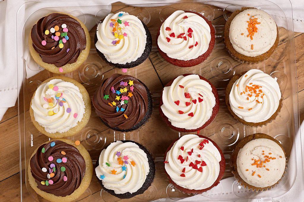 Dozen Assorted Classic Cupcakes · An assortment of our classic flavors - vanilla, chocolate, red velvet, and carrot cake, topped with an assortment of our most popular frostings and sprinkles. Suggested serving is 1 molly per person.