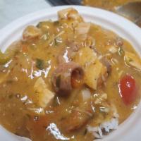 Crawfish, Chicken and Andouille Sausage Etouffee · Over rice.