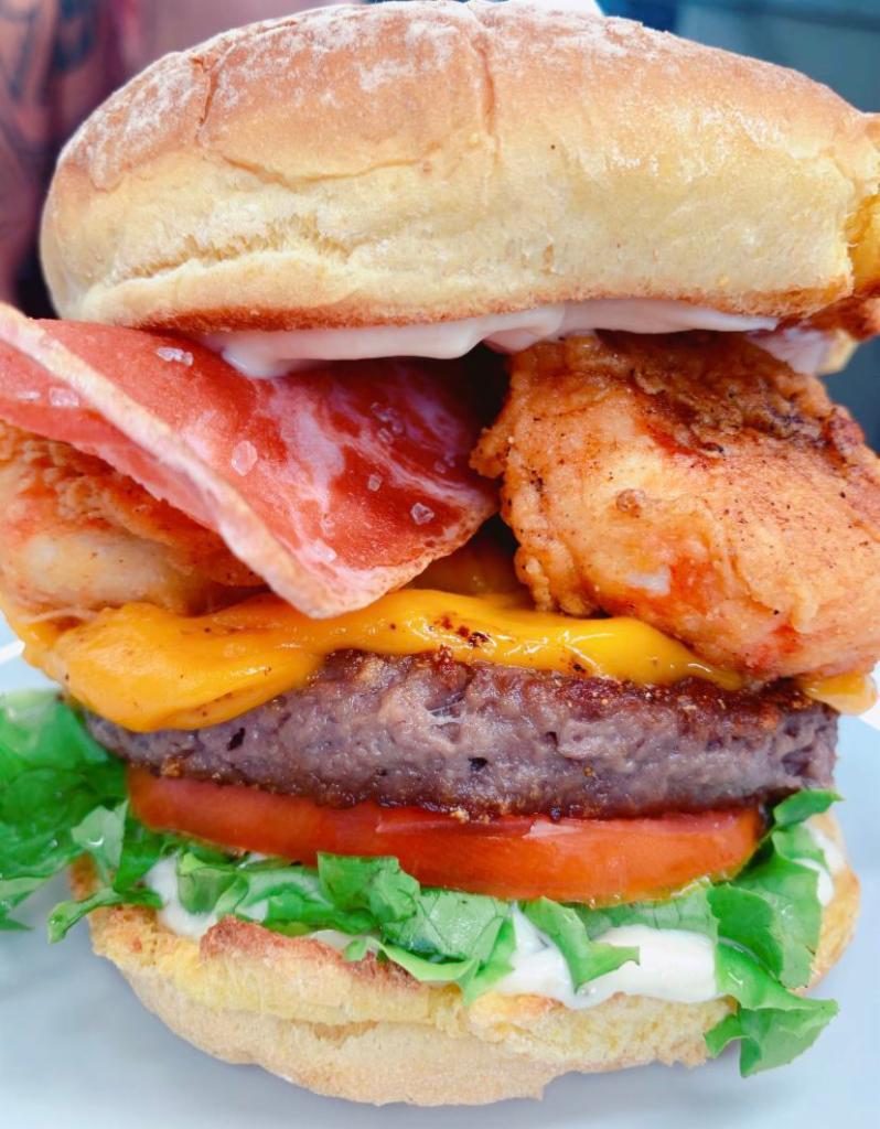 Thickass Burger · Potato bun, impossible 2.0 patty, follow your heart cheddar cheese, lettuce, tomato, sauteed onions, plant based shrimp, plant based bacon and topped with Badass sauce. Vegan.