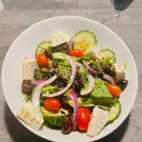 Greek Salad · Mixed greens, olives, onions, cucumbers, and tomatoes with homemade Greek dressing and feta ...