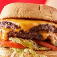 Classic Cheeseburger · Topped with cheddar, pickles, lettuce, and tomato. Served with 1 side and a pickle. Add add-...