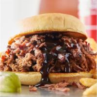 BBQ Sandwich · Your choice of meat piled high on a bun. Served with one side and a pickle.
