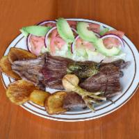 Carne Asada · Skirt steak, Mexican grilled onion, fried jalapeño , potato slices, salad, rice and beans.