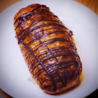 Pain Au Chocolate · A french classic, this pastry is filled with chocolate , topped with a chocolate drizzle 