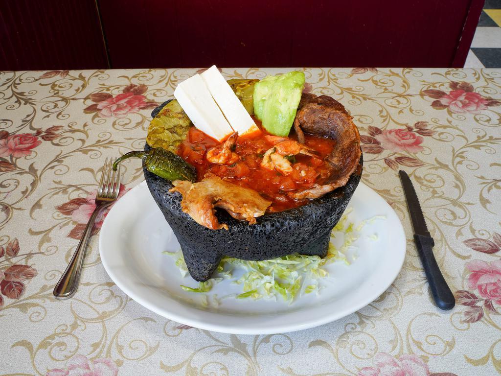 Molcajete Cielo Mar y Tierra · Served with steak, chicken and shrimp, salsa la diablo, avocado and cheese.