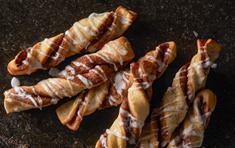 Cinnamon Twists · Rolled in a brown and white sugar cinnamon mixture and topped with a delicious powdered suga...