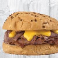 Beef N Cheddar · Tender rax roast beef sliced thin and stacked on an onion bun with cheddar cheese sauce.